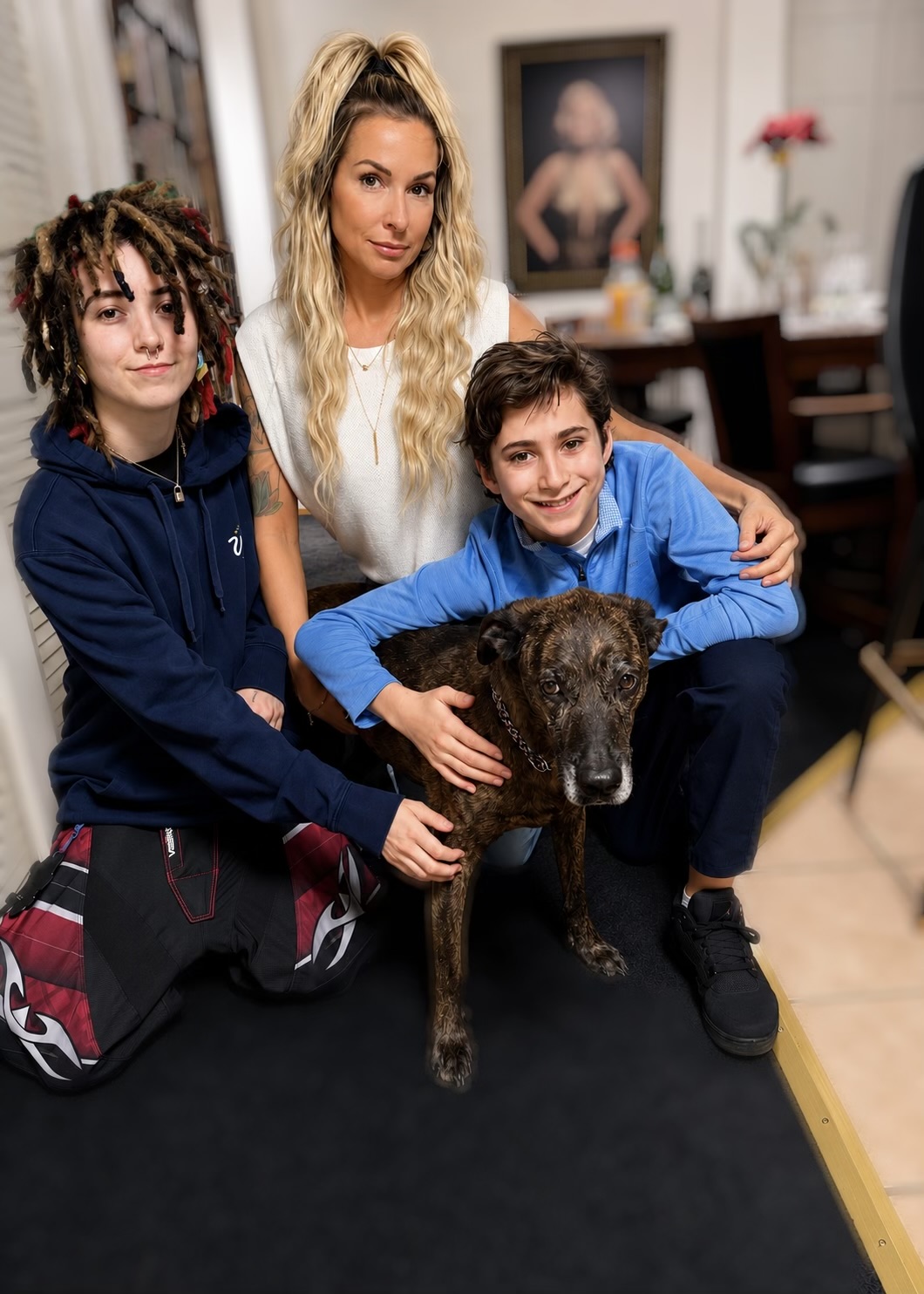 Mindy, founder of Mindy's Cleaning Services, at home with her two children and their dog