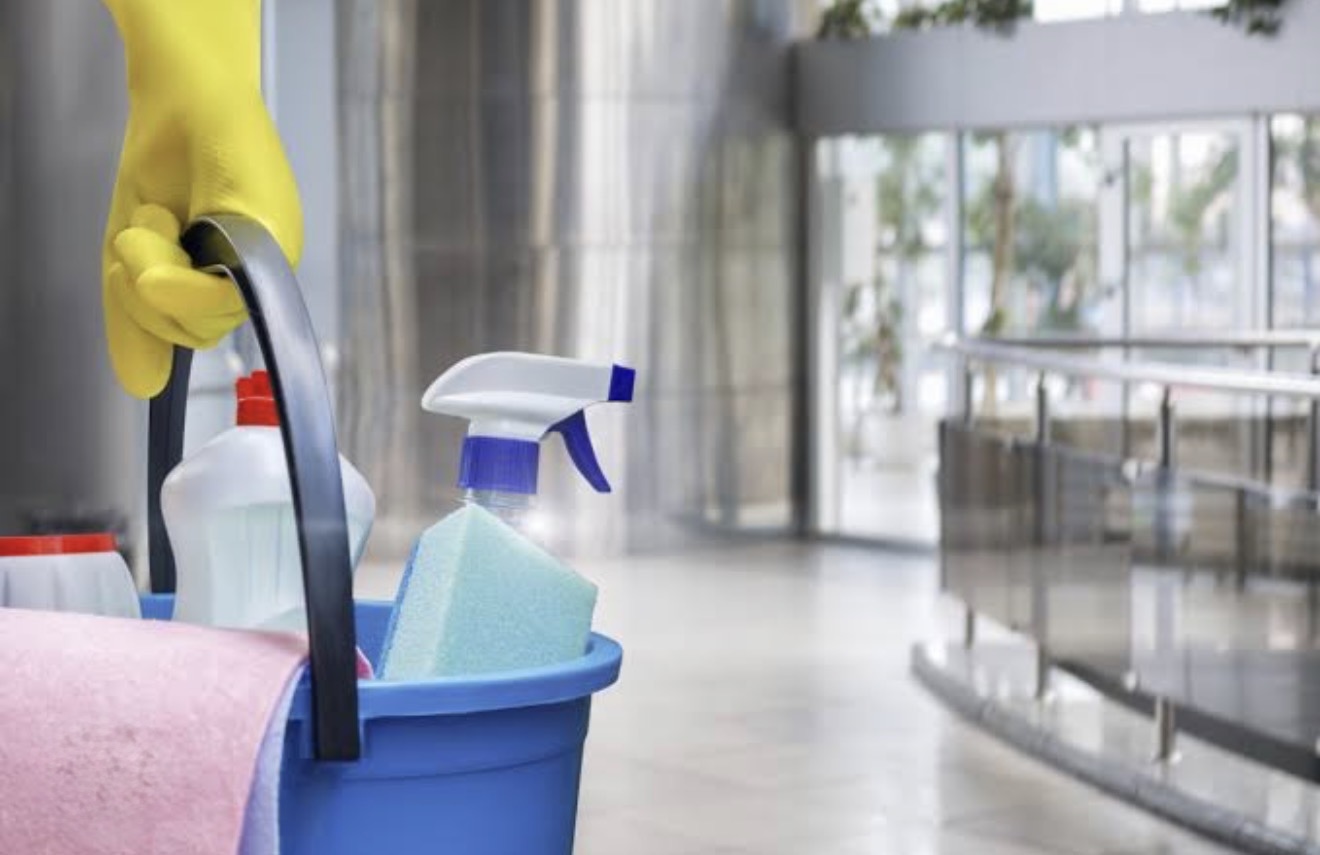 Cleaning caddy with spray bottle and sponge in a lobby